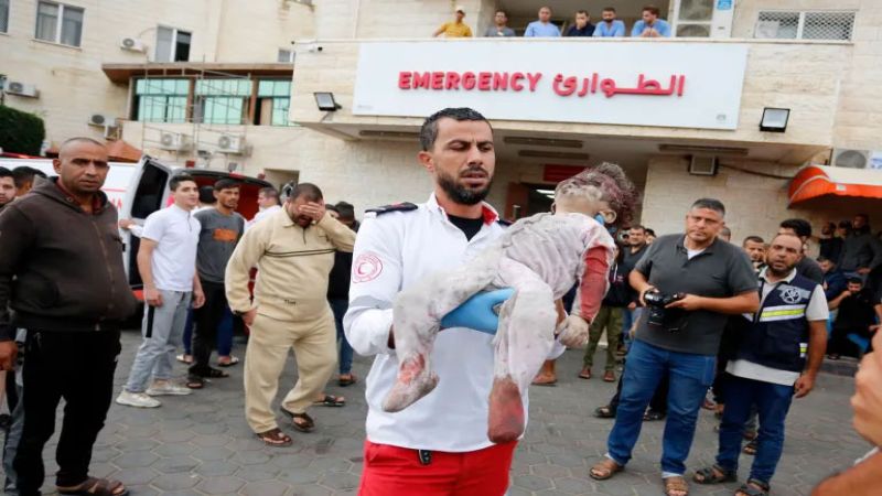 medic in Gaza holding baby